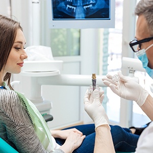 Dentist discussing dental implant options with curious patient