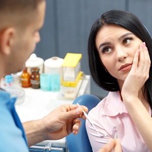 A dentist explaining a tooth extraction in Royal Palm Beach.