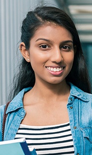 Smiling young woman wearing denim shirt