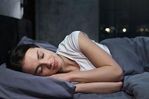 Woman sleeping after receiving dental implants in Jupiter