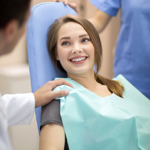 A woman smiling at her dental appointment.