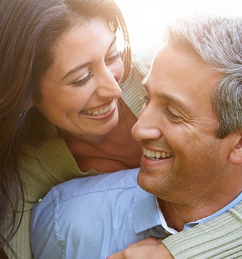 Smiling man and woman outdoors