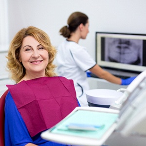 An older woman receiving dental implants near Wellington, FL.