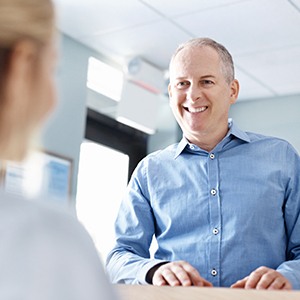 Man checking in at reception desk