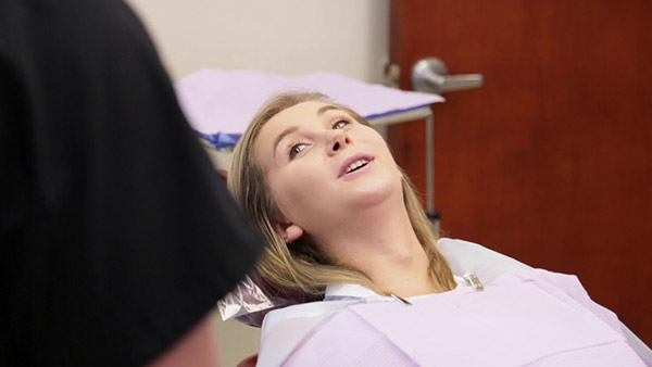 Young woman talking to her oral surgeon in Jupiter Florida