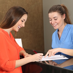 Woman checking in at front desk