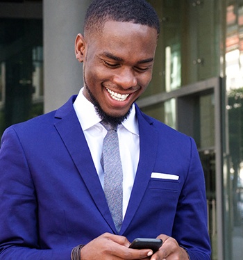 Man in business suit looking at cellphone