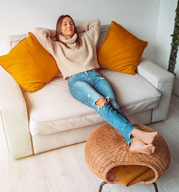 Woman resting at home on her sofa