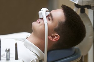  man with nitrous oxide mask 