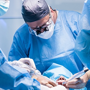 Oral surgeon treating patient