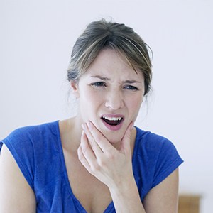Woman in pain holding jaw