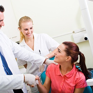 Woman shaking hands with oral surgeon