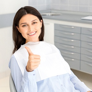 Female patient giving thumbs up for local anesthesia