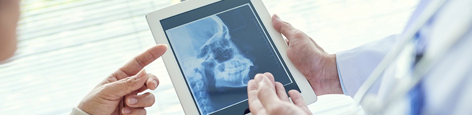 Oral surgeons looking at skull x-rays