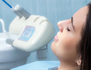 Woman in dental chair with eyes closed