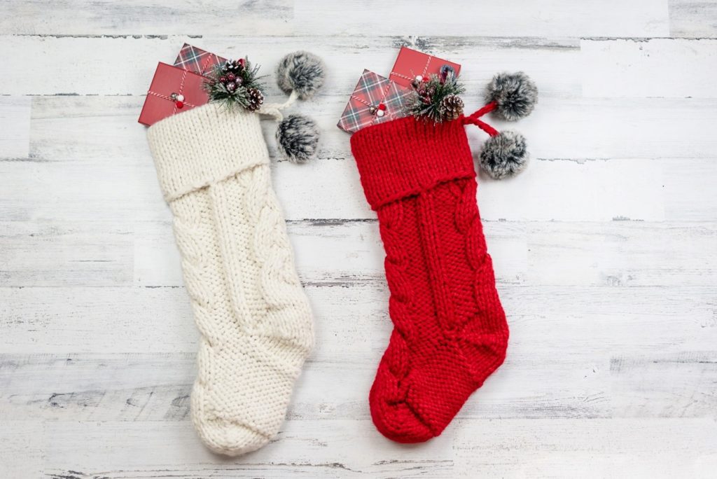 White and red holiday stockings filled with presents