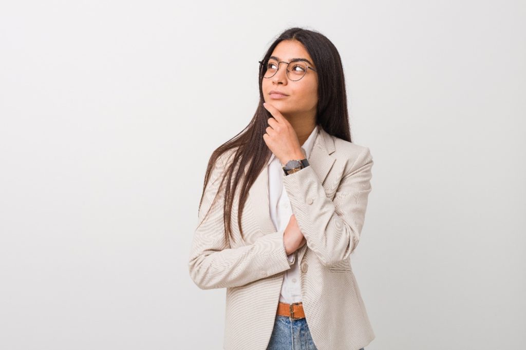 Woman with glasses wondering