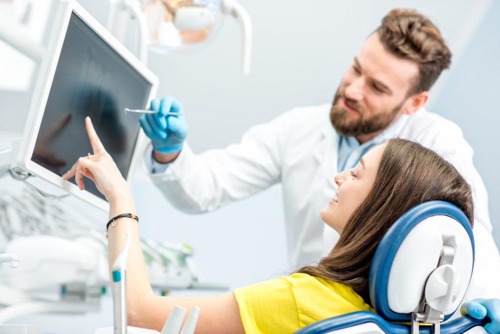 Dentist showing patient X-ray