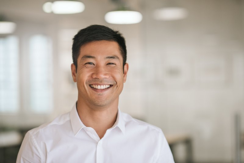 man with dental implant smiling