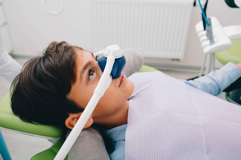 child at dentist’s office receiving sedation dentistry