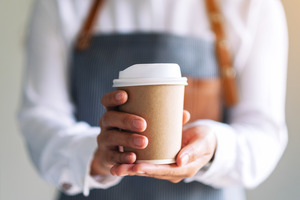 Close-up of coffee held by a waitress