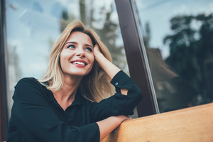 Woman smiling and looking out a window