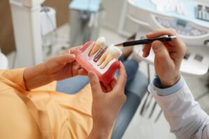 Woman learning more about dental implants from her oral surgeon